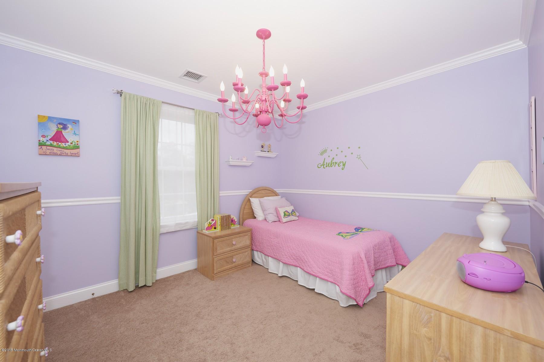 272 E Road Middletown, NJ 07718 - Photo 17 of 22 a bedroom with a bed and a chandelier