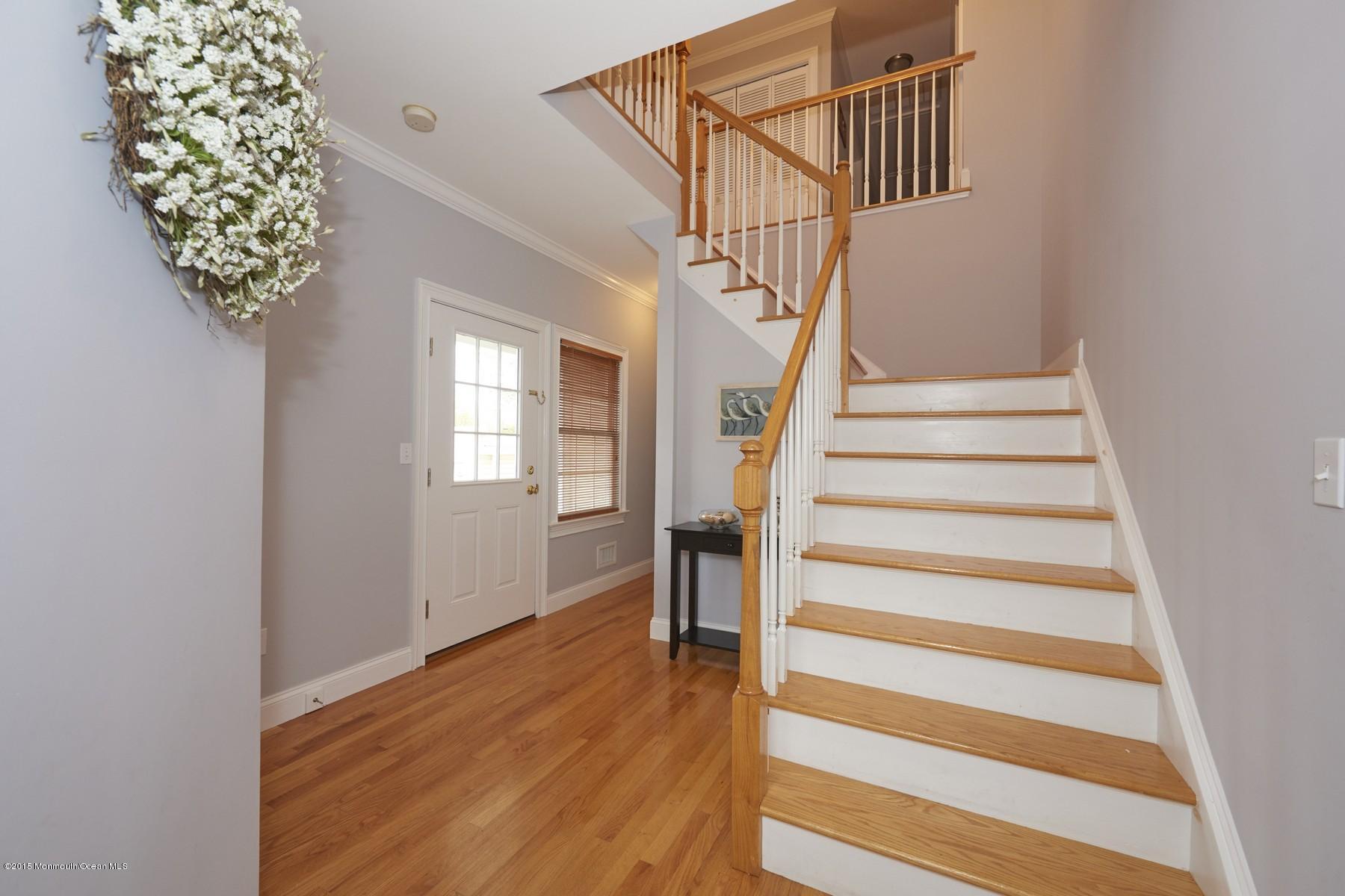 272 E Road Middletown, NJ 07718 - Photo 4 of 22 a view of entryway with wooden floor and stairs