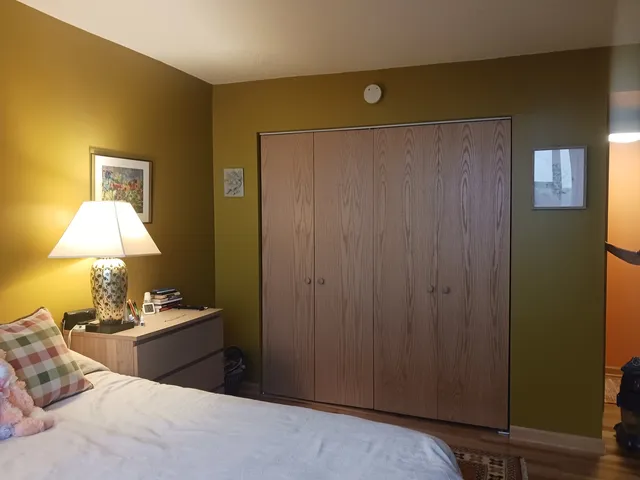 a bedroom with a bed and a lamp on table
