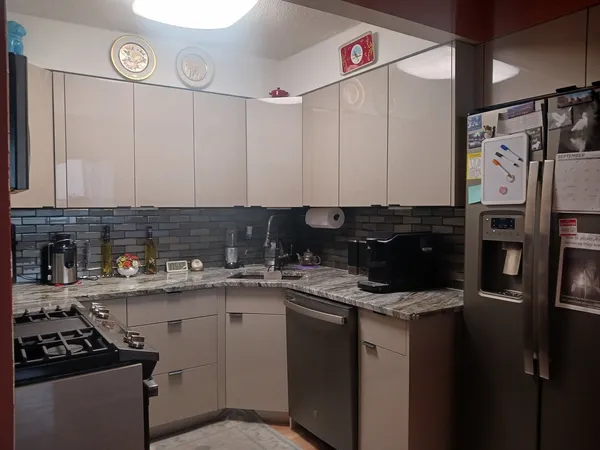 a kitchen with stainless steel appliances granite countertop a sink stove and refrigerator
