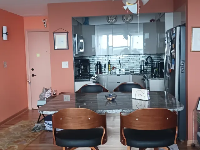 a living room with dining table and chairs