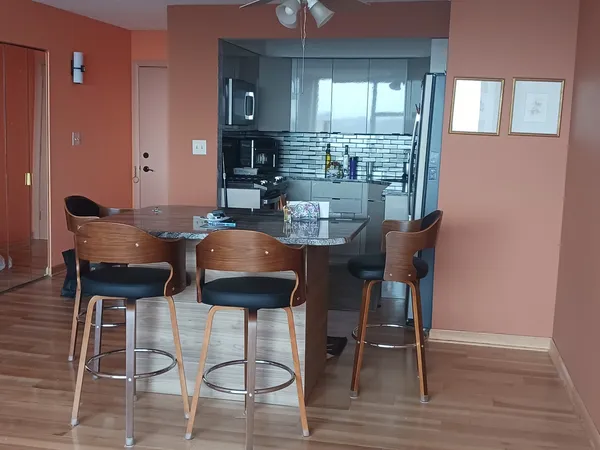 a view of a dining room with furniture and wooden floor