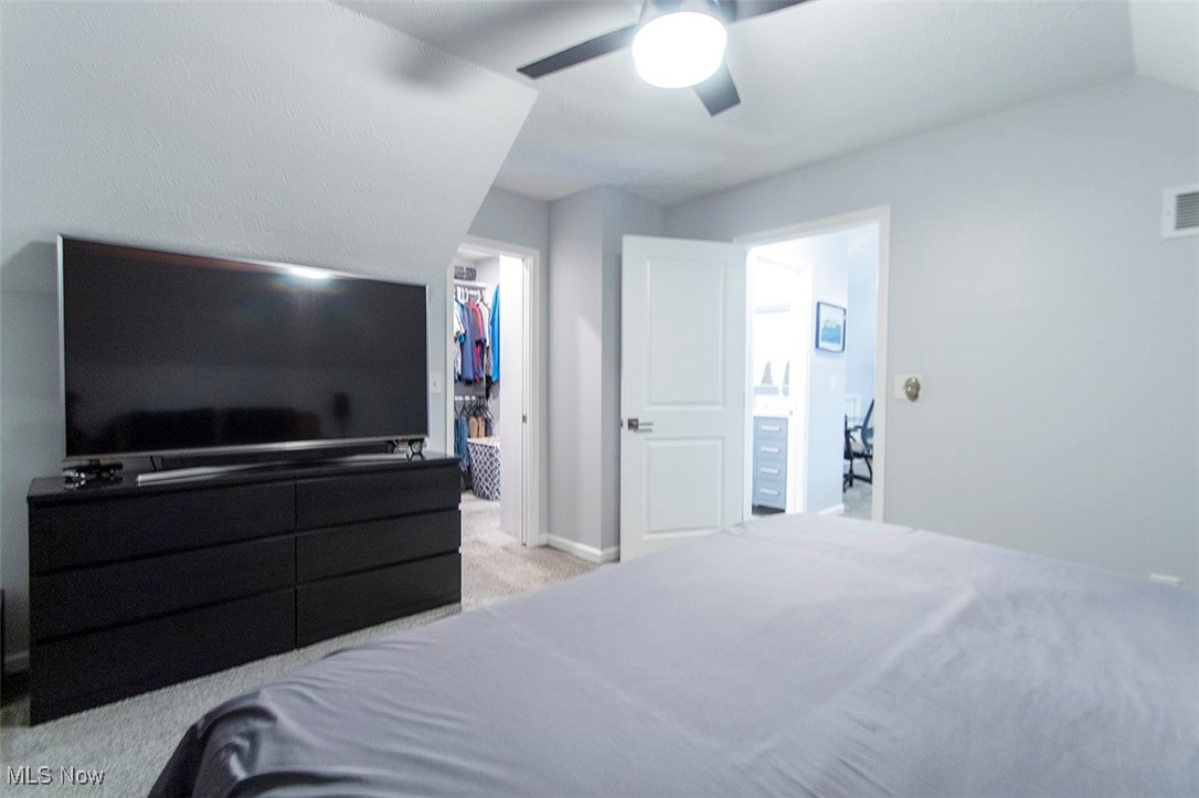 5859 Buffham Road Seville, OH 44273 - Photo 26 of 34 Bedroom featuring carpet flooring, a spacious closet, ceiling fan, and lofted ceiling