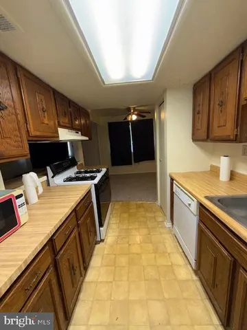 a large kitchen with a sink and a stove top oven