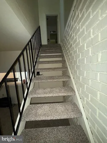 a view of staircase with white walls