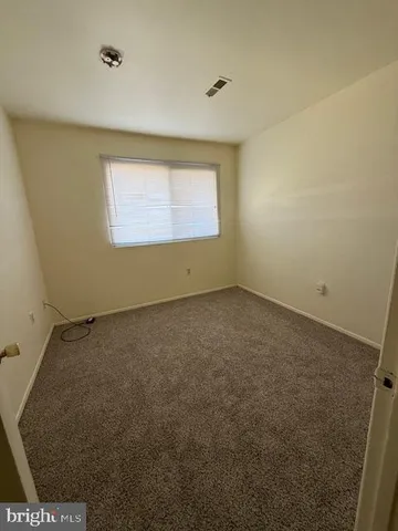 an empty room with a empty space and a window