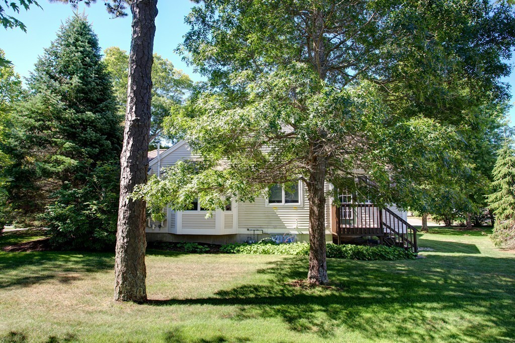 56 Pine Hill Boulevard, Unit 72 Mashpee, MA 02649 - Photo 6 of 12 a front view of a house with a yard