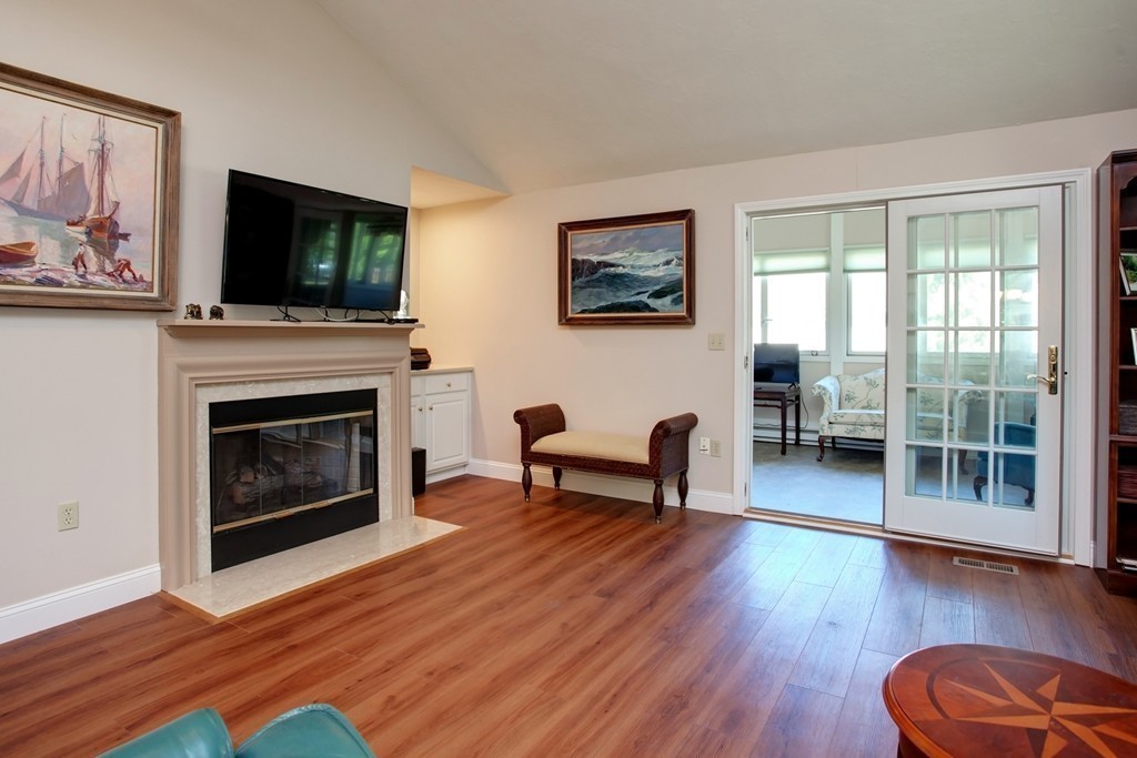 56 Pine Hill Boulevard, Unit 72 Mashpee, MA 02649 - Photo 8 of 12 a living room with furniture fireplace and flat screen tv
