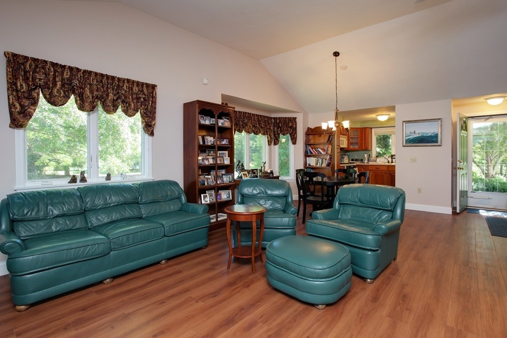 56 Pine Hill Boulevard, Unit 72 Mashpee, MA 02649 - Photo 9 of 12 a living room with furniture and a large window