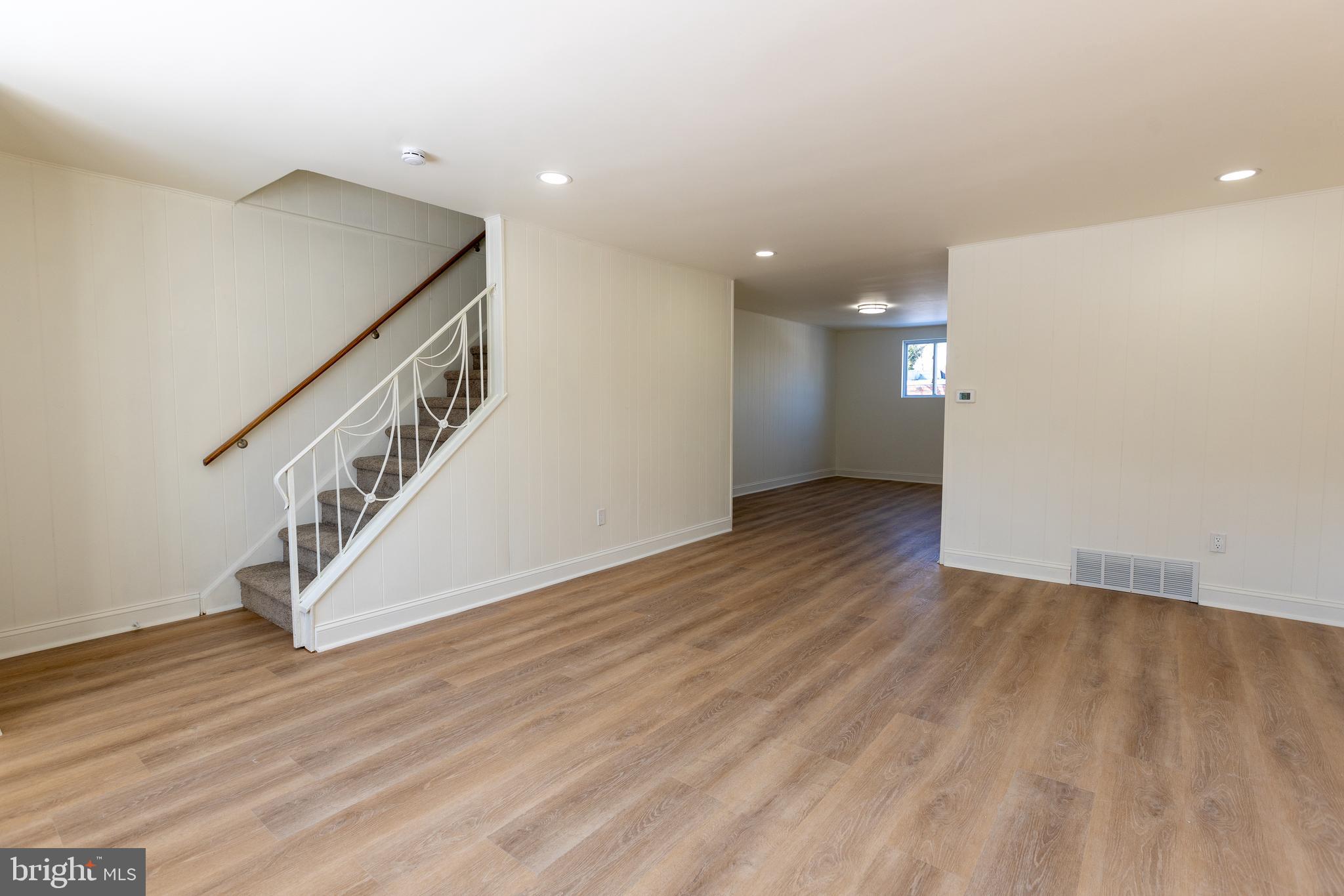 1218 Harshaw Road Brookhaven, PA 19015 - Photo 3 of 21 a view of an empty room with wooden floor and stairs