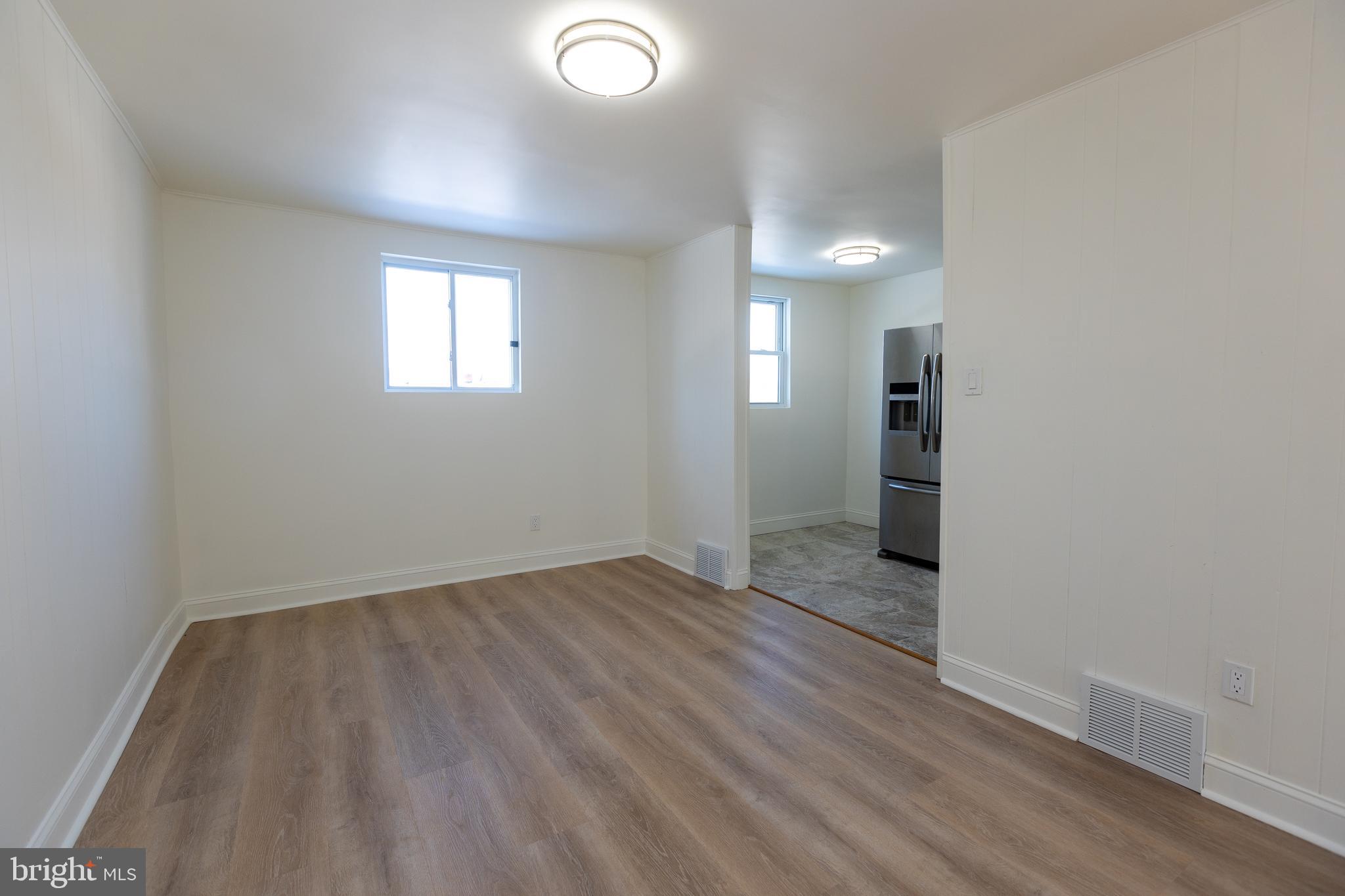1218 Harshaw Road Brookhaven, PA 19015 - Photo 5 of 21 wooden floor in an empty room with a window