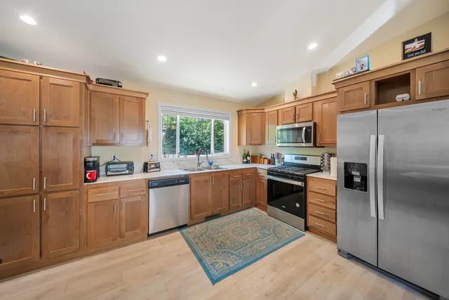 a bedroom with a bed a chandelier and a chair