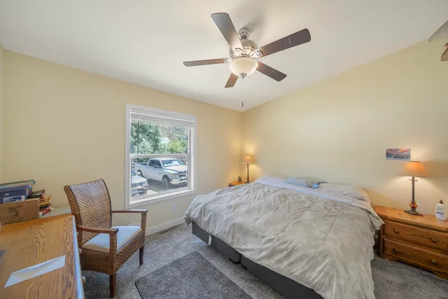a bedroom with a bed and a large window