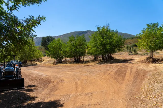 a backyard of a house with a yard and outdoor seating