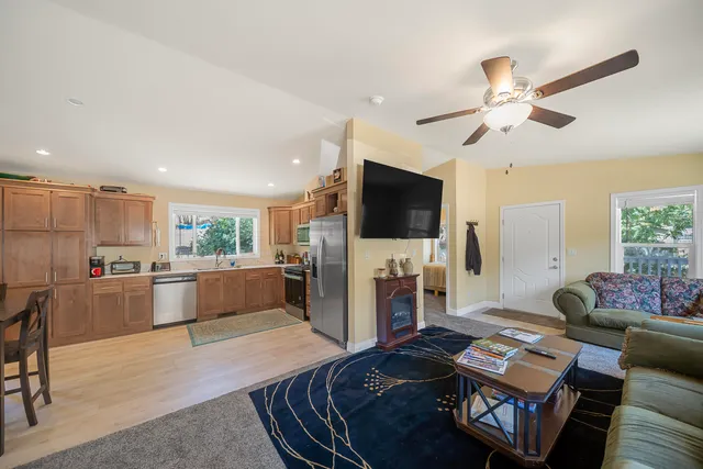 a kitchen with refrigerator and chairs