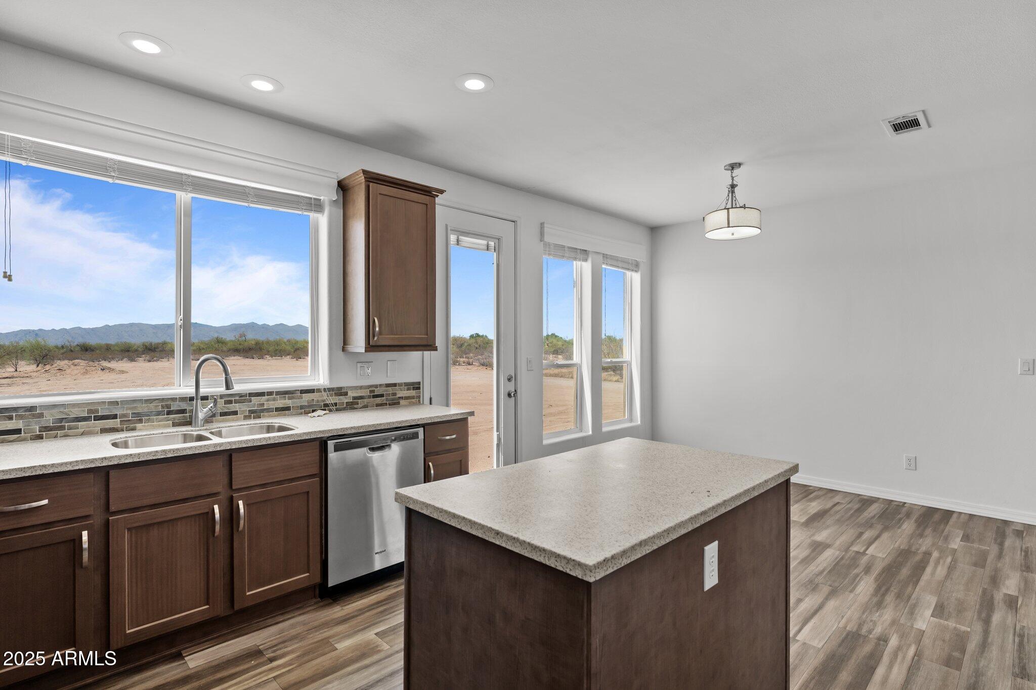 20909 West Bradley Road Wittmann, AZ 85361 - Photo 8 of 37 a kitchen with a stove a sink and a refrigerator