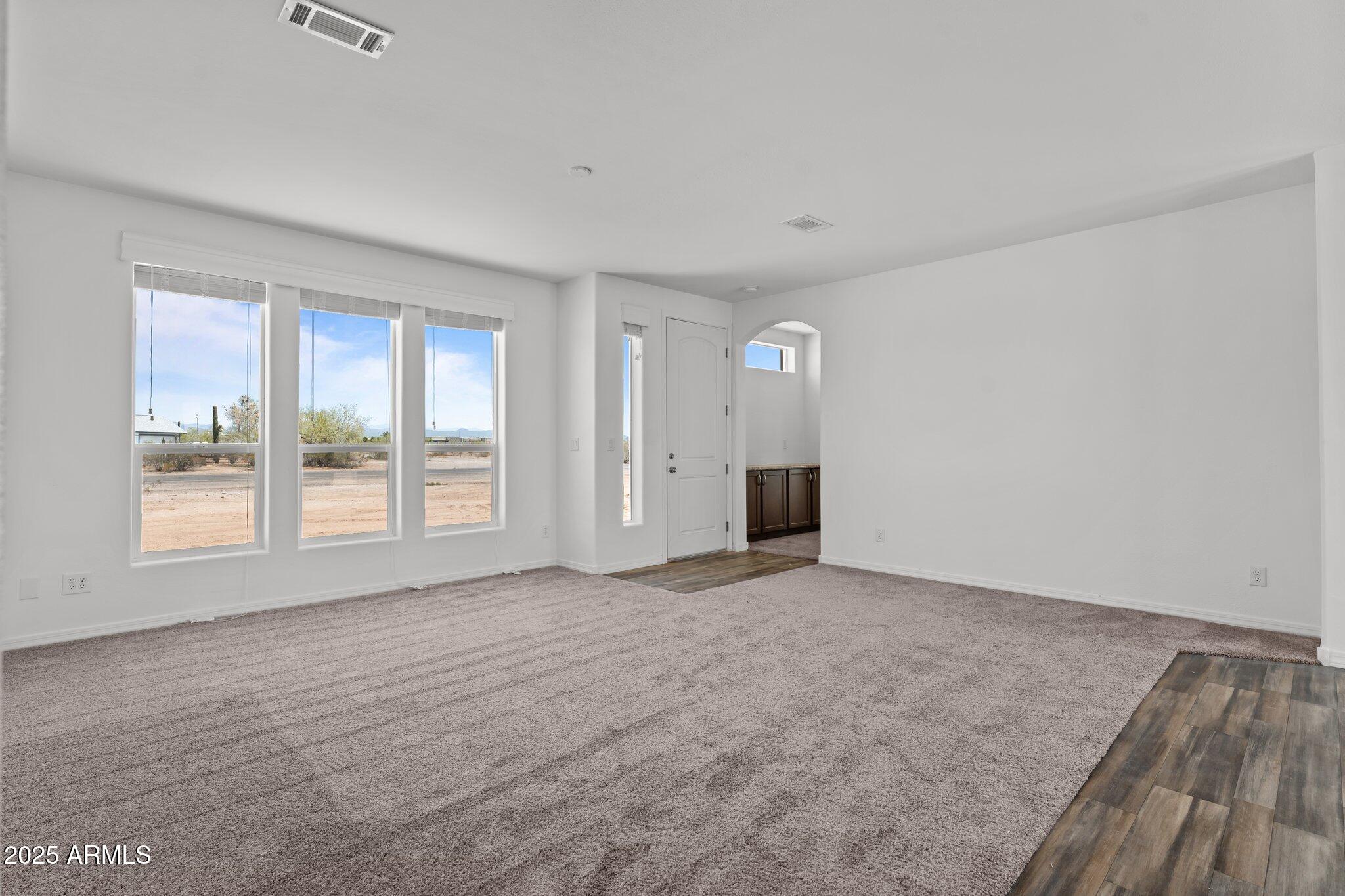 20909 West Bradley Road Wittmann, AZ 85361 - Photo 15 of 37 a view of an empty room with a window