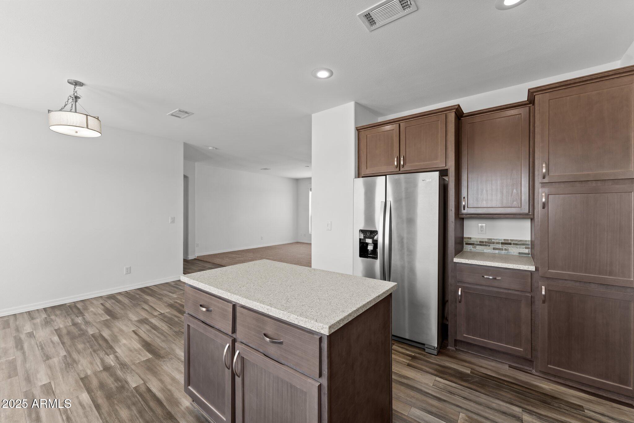 20909 West Bradley Road Wittmann, AZ 85361 - Photo 20 of 37 a kitchen with a refrigerator and a sink