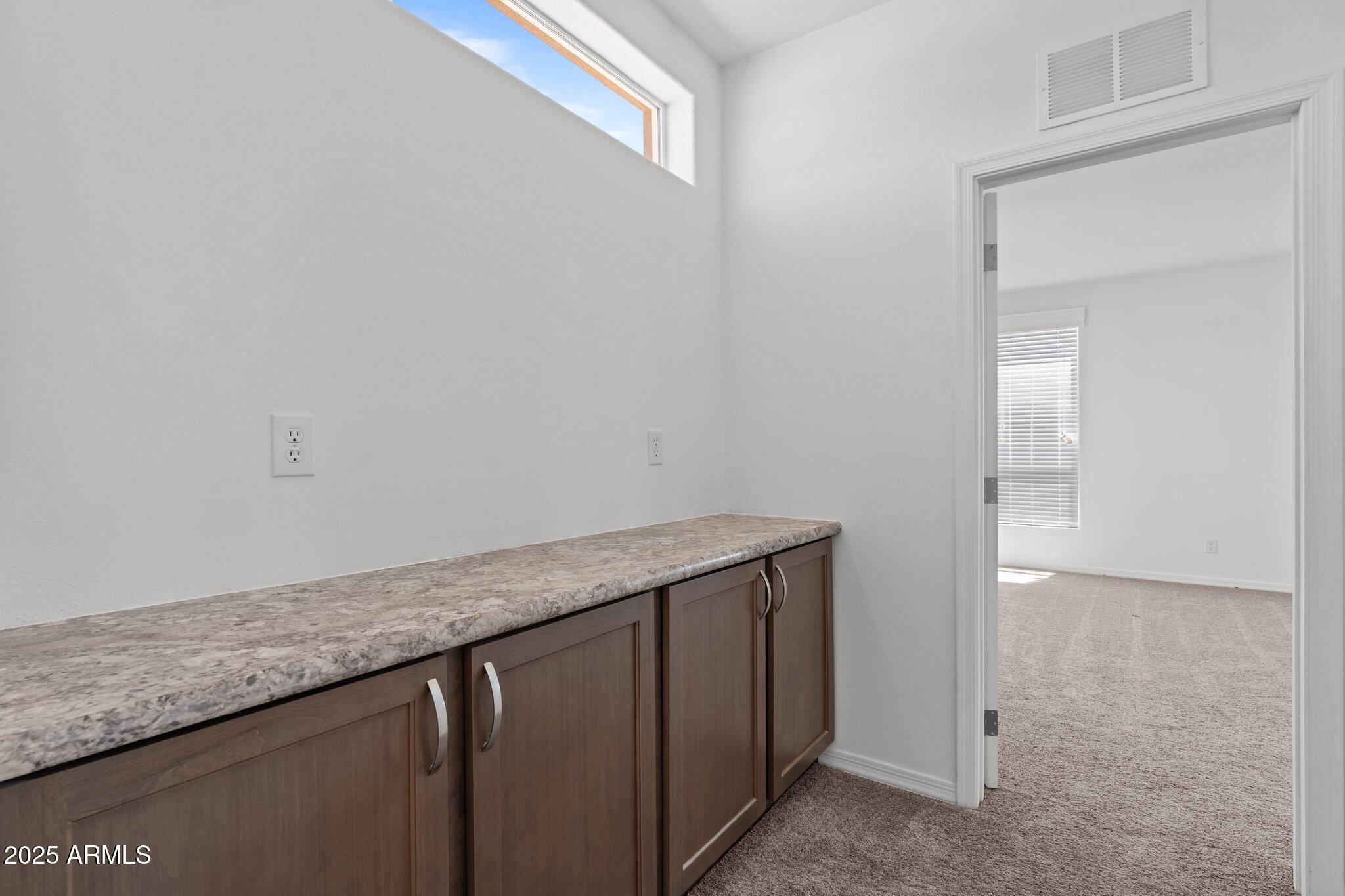 20909 West Bradley Road Wittmann, AZ 85361 - Photo 21 of 37 a utility room with granite countertop cabinets and sink