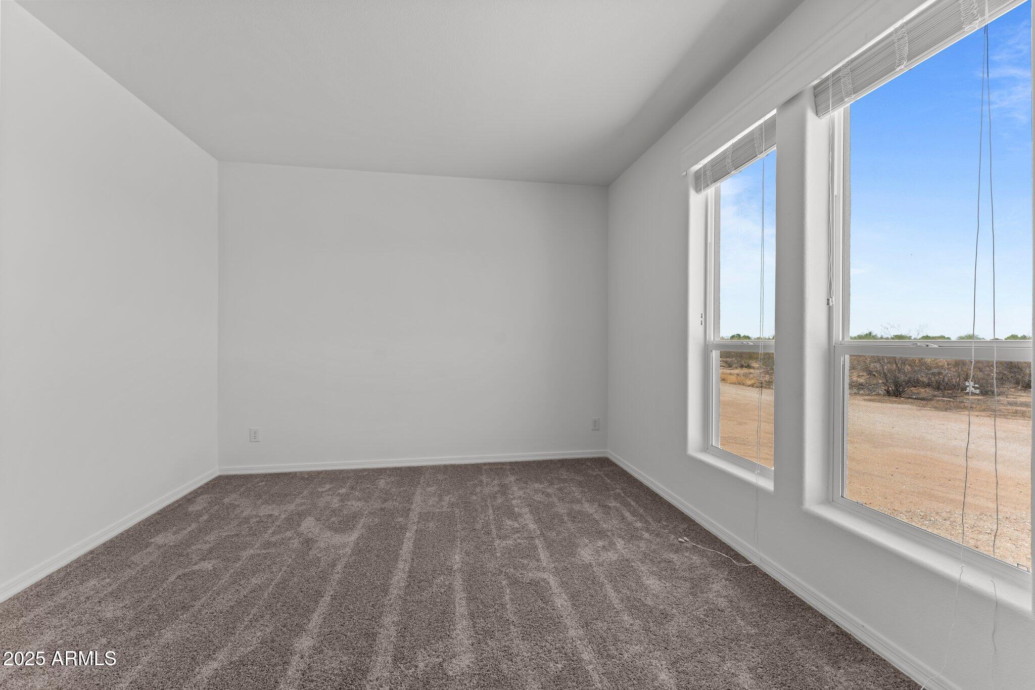 20909 West Bradley Road Wittmann, AZ 85361 - Photo 26 of 37 wooden floor and window in an empty room