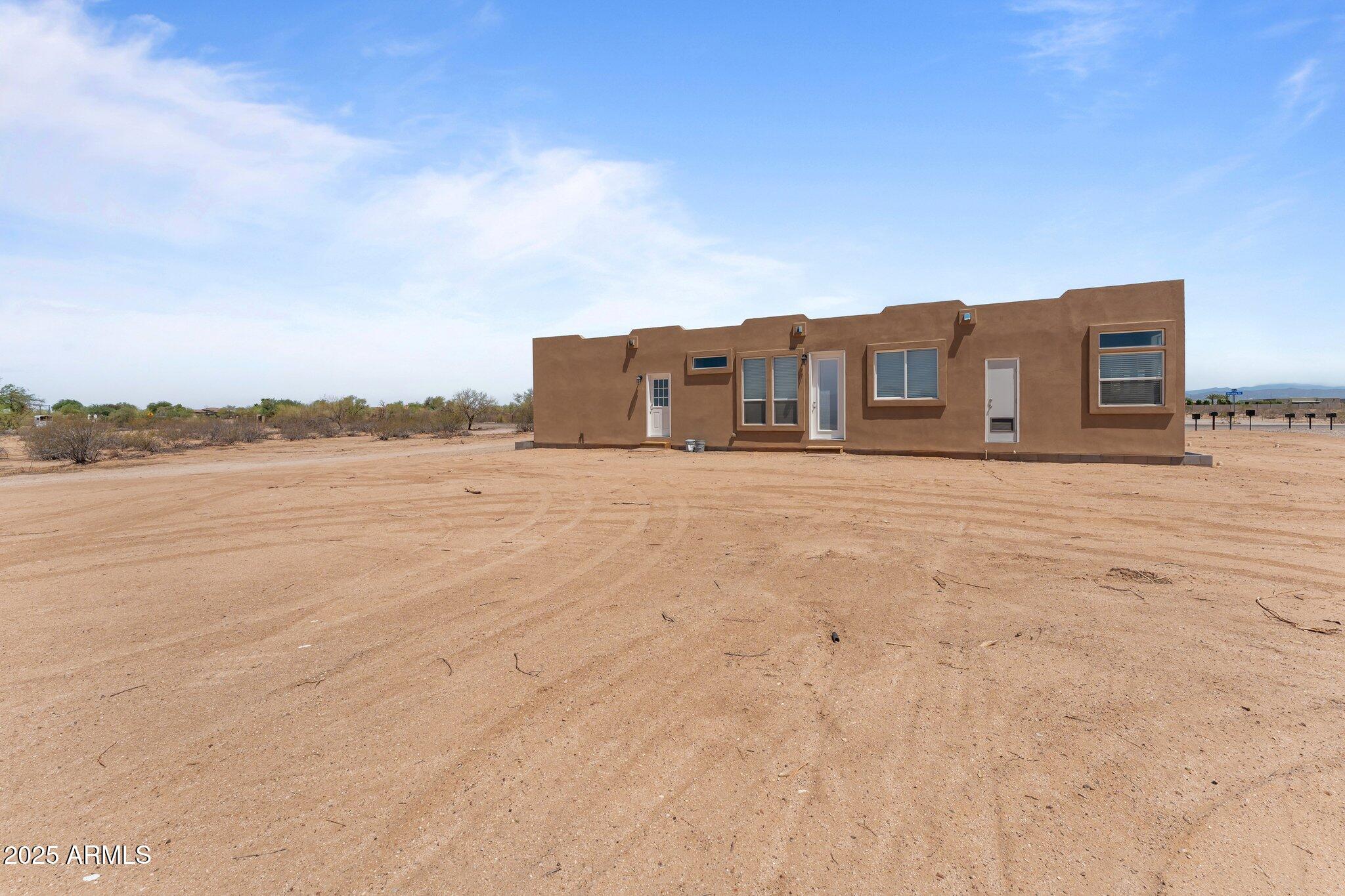 20909 West Bradley Road Wittmann, AZ 85361 - Photo 28 of 37 a big house with a big yard and large trees