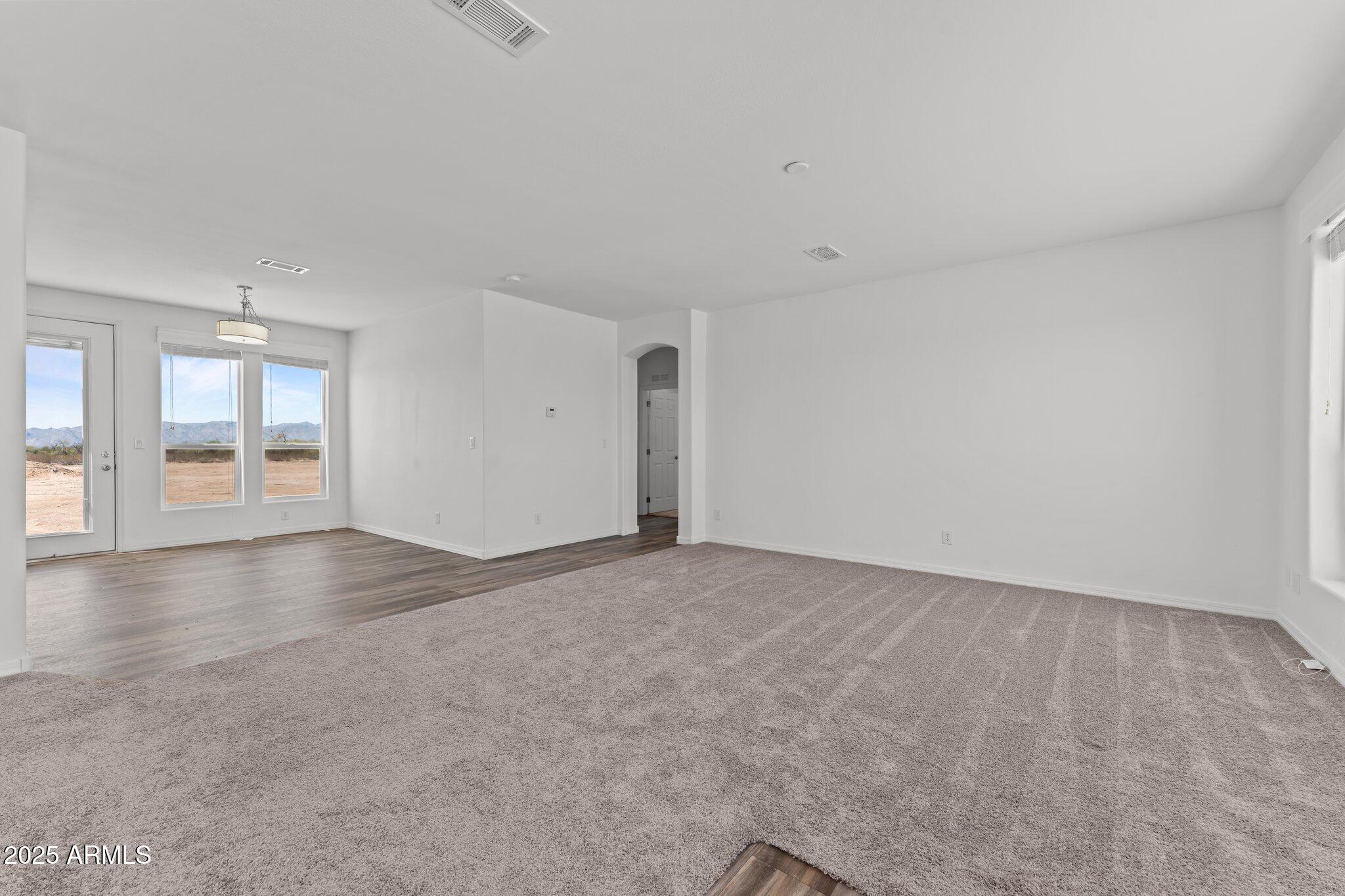 20909 West Bradley Road Wittmann, AZ 85361 - Photo 5 of 37 a view of an empty room with a window