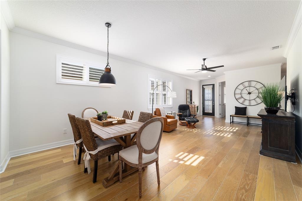 9710 Southwest 76th Lane Road Ocala, FL 34481 - Photo 12 of 45 a view of a dining room with furniture and wooden floor