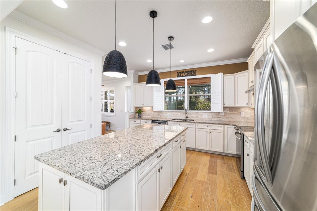 9710 Southwest 76th Lane Road Ocala, FL 34481 - Photo 14 of 45 a kitchen with stainless steel appliances granite countertop a sink stove and refrigerator