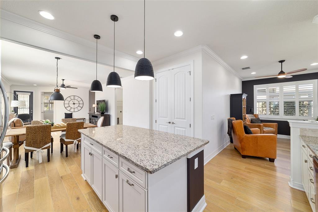 9710 Southwest 76th Lane Road Ocala, FL 34481 - Photo 17 of 45 an open kitchen with granite countertop a stove and white cabinets
