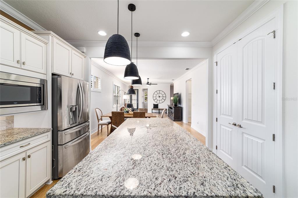 9710 Southwest 76th Lane Road Ocala, FL 34481 - Photo 18 of 45 a kitchen with stainless steel appliances granite countertop a refrigerator a stove and a sink
