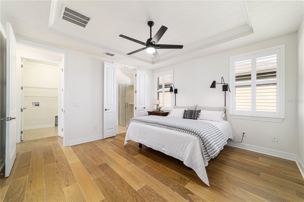 9710 Southwest 76th Lane Road Ocala, FL 34481 - Photo 22 of 45 a bedroom with a bed and wooden floor