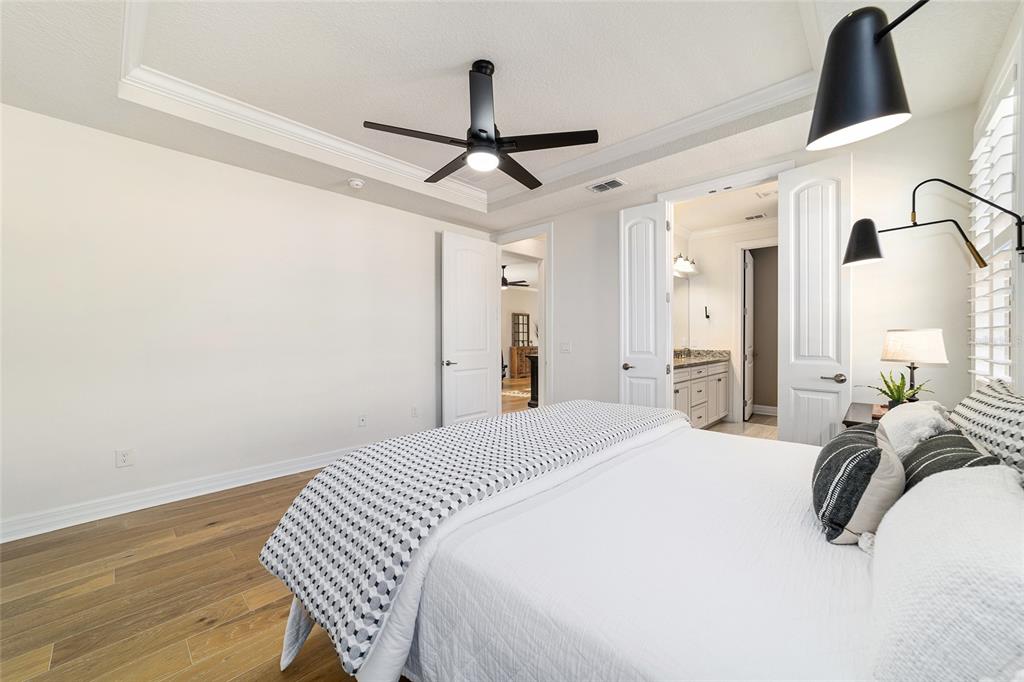 9710 Southwest 76th Lane Road Ocala, FL 34481 - Photo 23 of 45 a bedroom with a bed and a chandelier