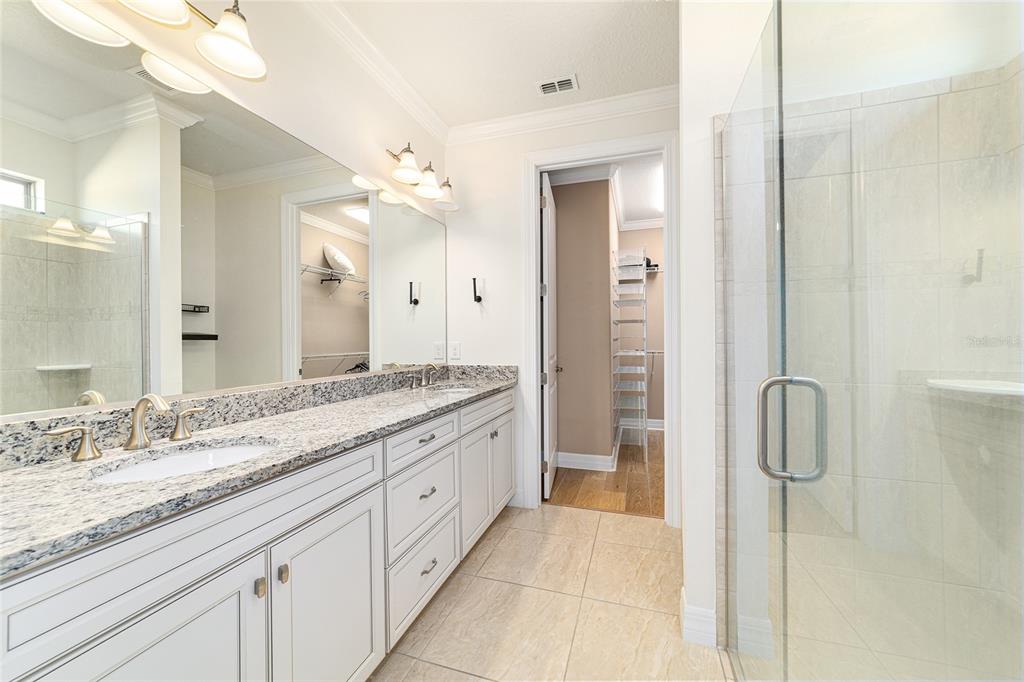 9710 Southwest 76th Lane Road Ocala, FL 34481 - Photo 25 of 45 a spacious bathroom with a granite countertop sink and a mirror