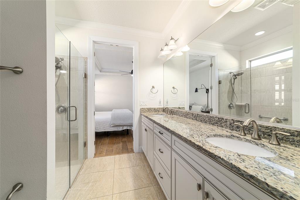 9710 Southwest 76th Lane Road Ocala, FL 34481 - Photo 26 of 45 a en suite bathroom with a granite countertop sink a toilet and shower