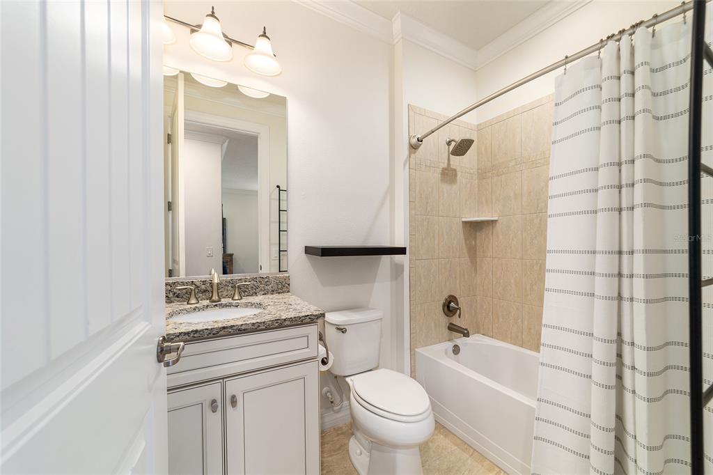 9710 Southwest 76th Lane Road Ocala, FL 34481 - Photo 30 of 45 a bathroom with a granite countertop sink toilet mirror and shower