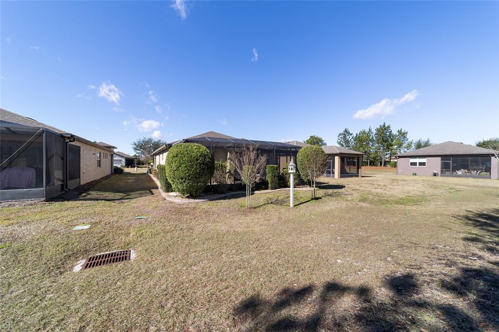 9710 Southwest 76th Lane Road Ocala, FL 34481 - Photo 35 of 45 a house with yard and a parking space