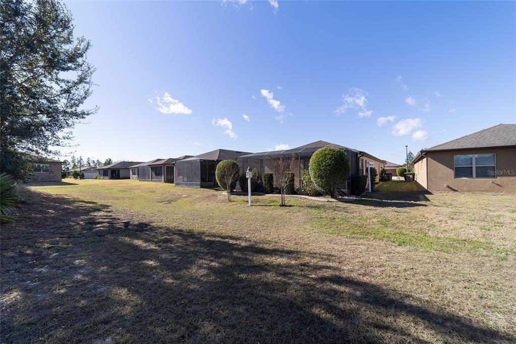 9710 Southwest 76th Lane Road Ocala, FL 34481 - Photo 39 of 45 a view of a house with a yard