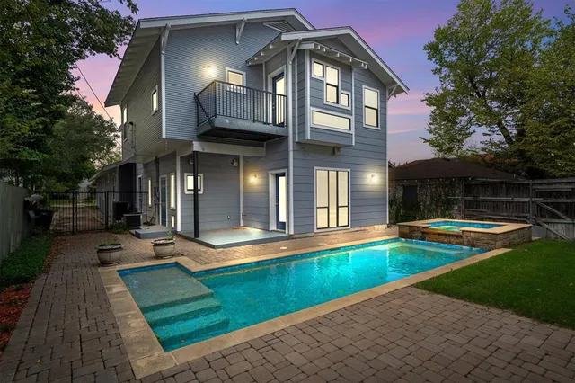 a view of a house with swimming pool and sitting area