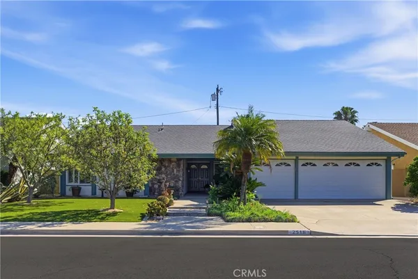 a house with palm tree in front of it