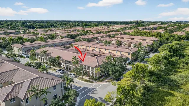 a front view of a house with a tree