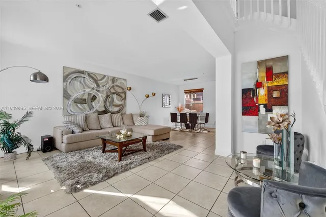 a dining room with stainless steel appliances kitchen island granite countertop a table and chairs