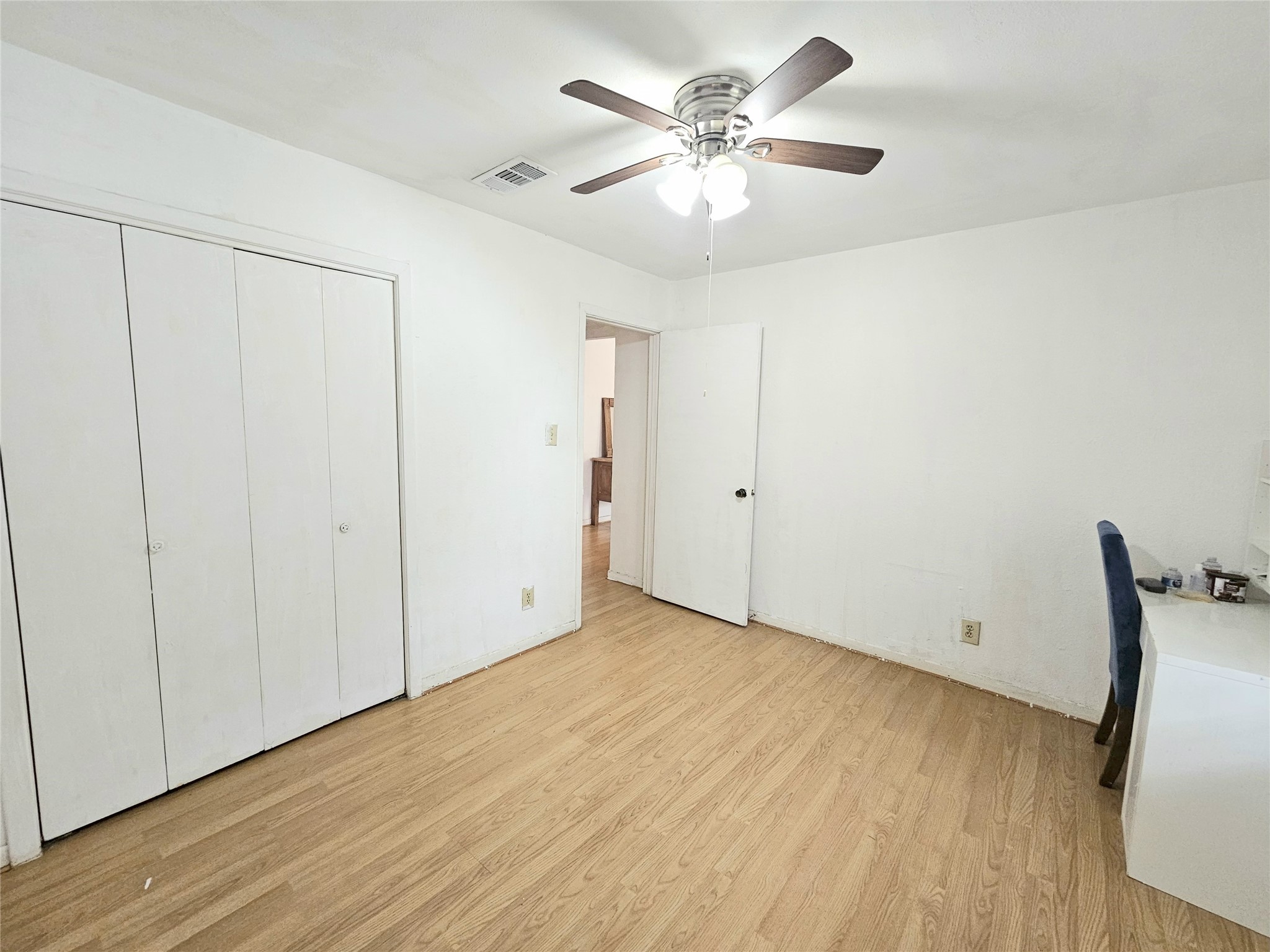 6201 Ranchester Drive, Unit 1 Houston, TX 77036 - Photo 11 of 26 an empty room with wooden floor chandelier fan and windows