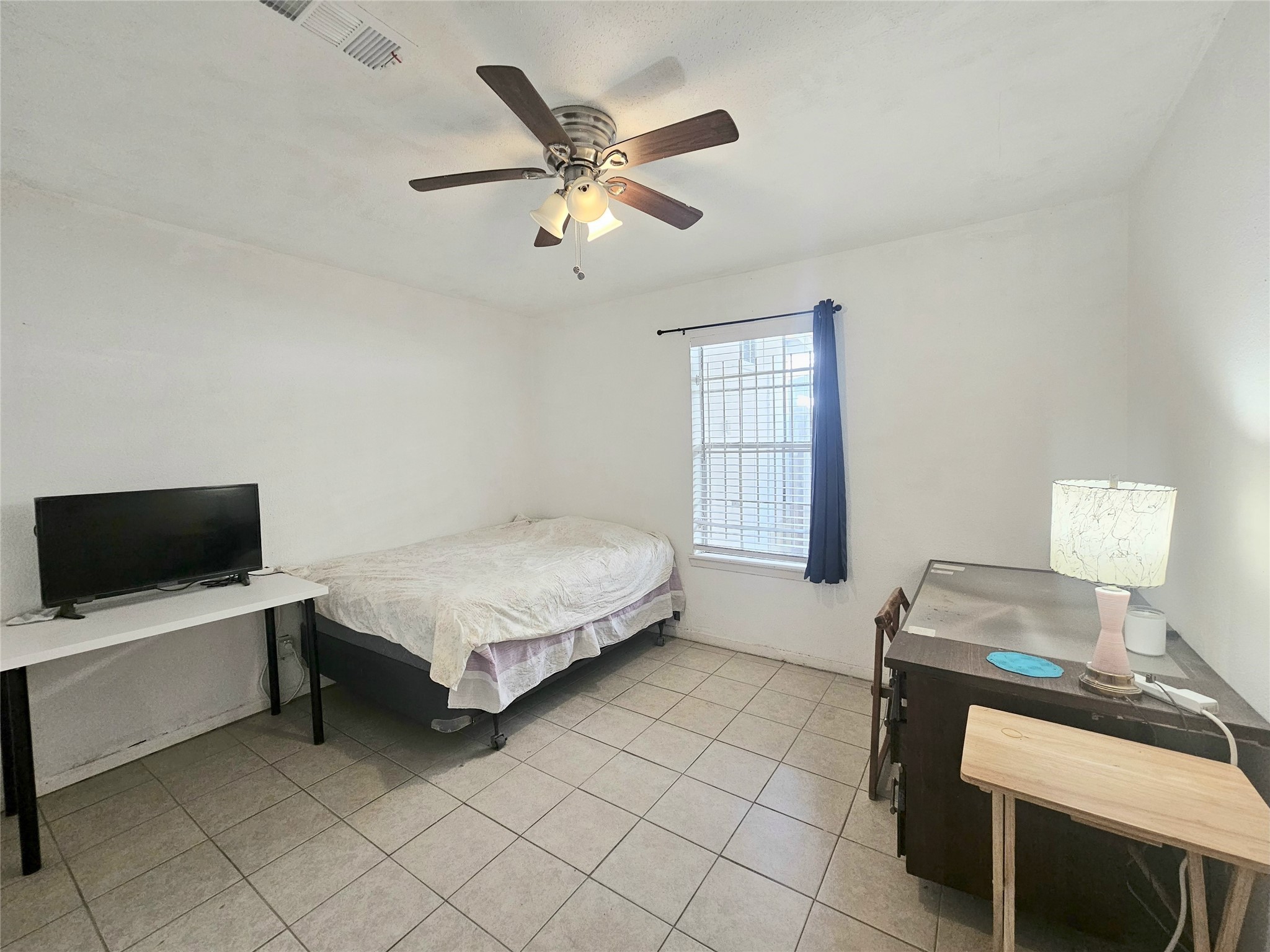 6201 Ranchester Drive, Unit 1 Houston, TX 77036 - Photo 12 of 26 a bedroom with a bed and a tv on table