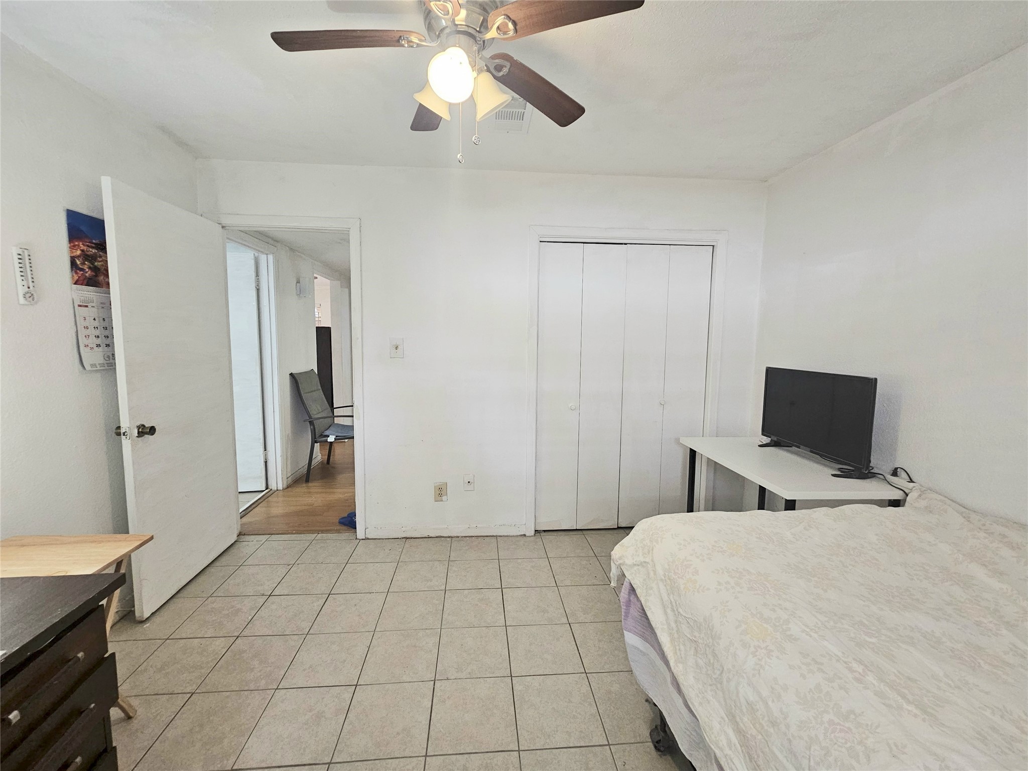 6201 Ranchester Drive, Unit 1 Houston, TX 77036 - Photo 13 of 26 a bedroom with a bed and a flat tv screen