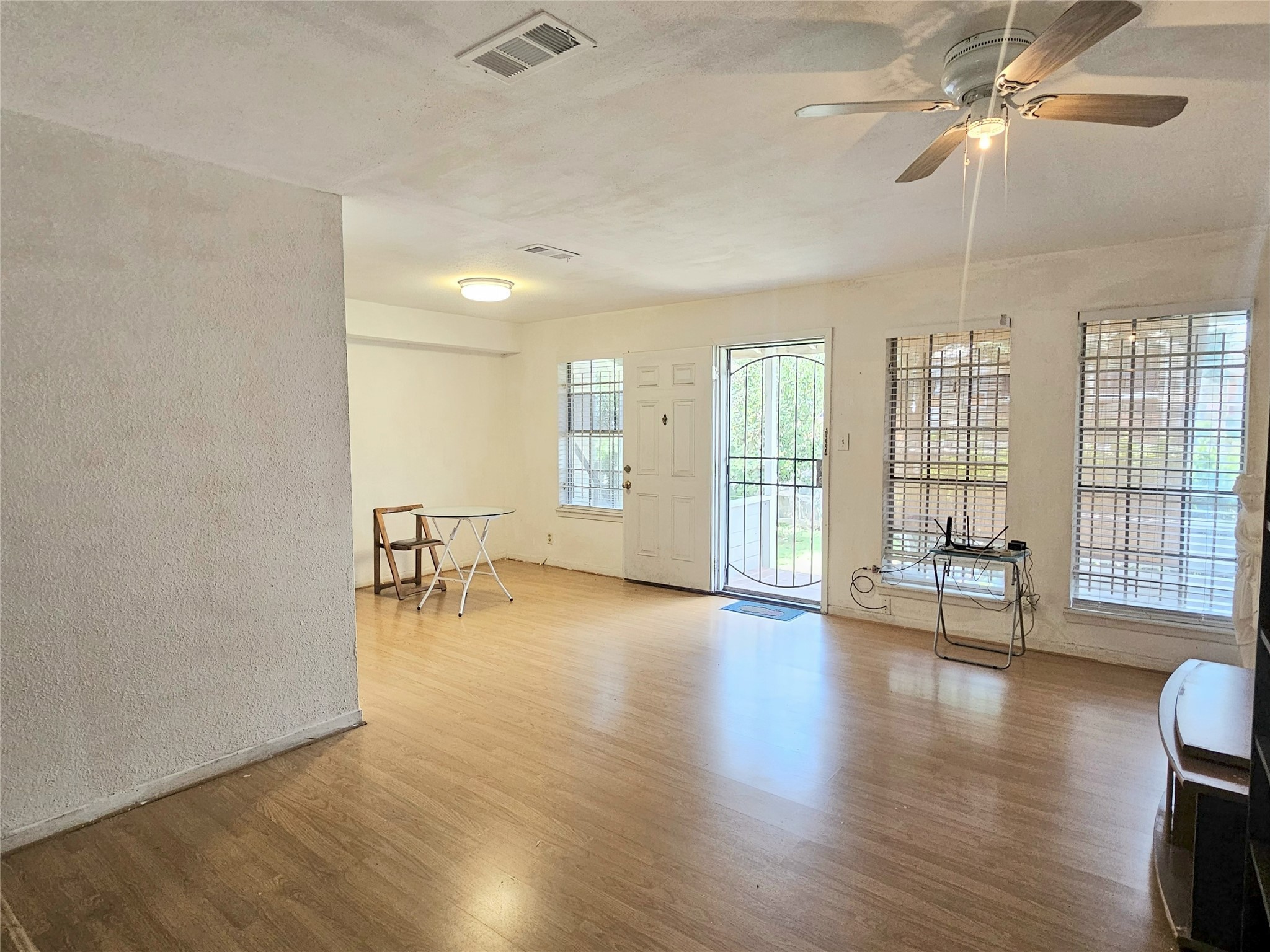 6201 Ranchester Drive, Unit 1 Houston, TX 77036 - Photo 4 of 26 a view of an empty room with wooden floor and a window