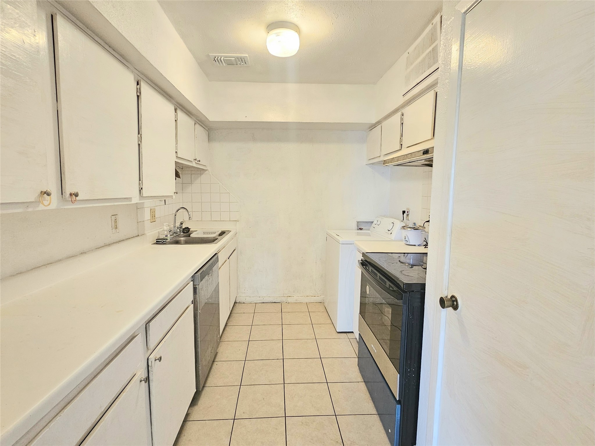 6201 Ranchester Drive, Unit 1 Houston, TX 77036 - Photo 7 of 26 a kitchen with a sink cabinets and appliances