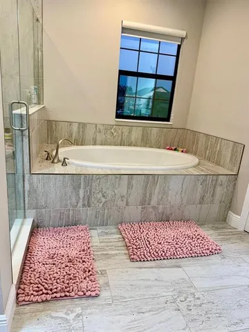a bathroom with a bathtub and window
