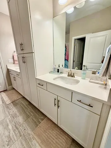a bathroom with a double vanity sink and mirror
