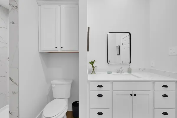a spacious bathroom with double vanity sink a mirror and vanity