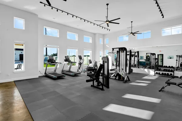 a view of gym equipment and kitchen view